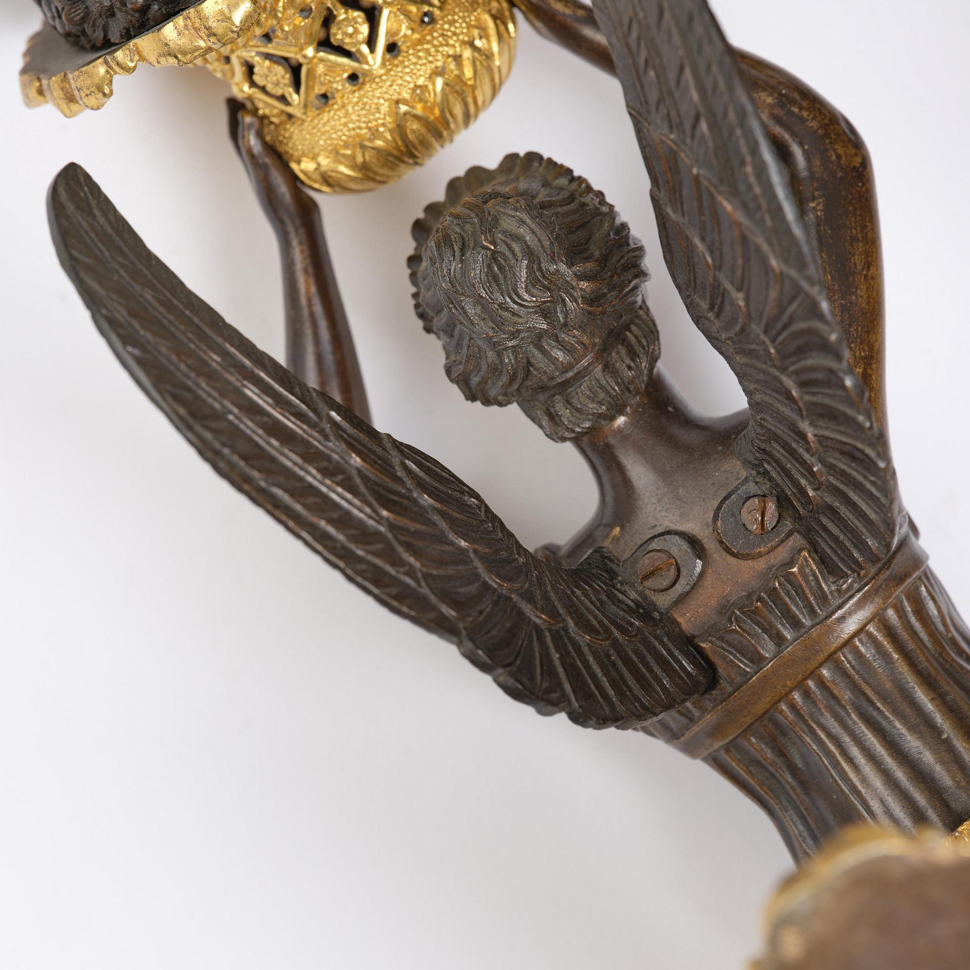 A pair of French Empire five-branch gilt and patinated bronze appliques, first part 19th century.