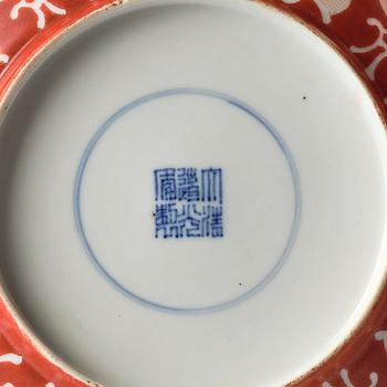 A coral-red reverse decorated dish, Qing dynasty with Guangxu mark and of the period (1875-1908).