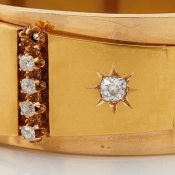 An 18K gold bracelet set with old-cut diamonds.