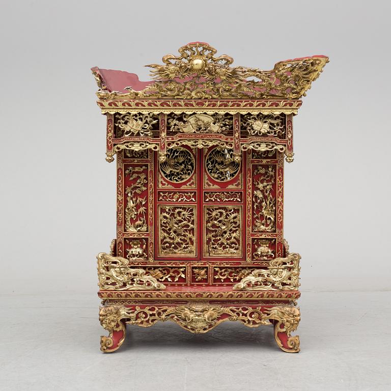 A Chinese red lacqured altar cabinet, late Qing dynasty/early 20th century.