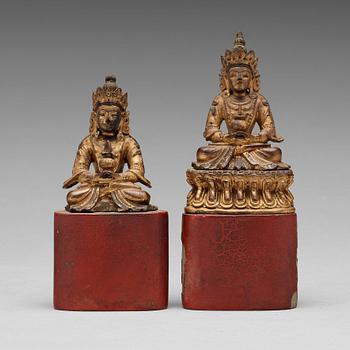 579. Two Sino-tibetan wooden and lacquered figures of buddha, late 19th Century.