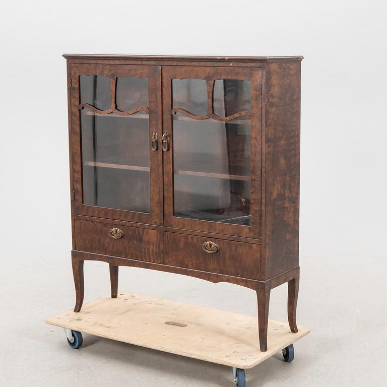 A 1920s  stained beech display cabinet.