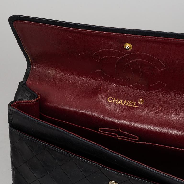 CHANEL, a quilted black leather 'Double Flap Bag'.