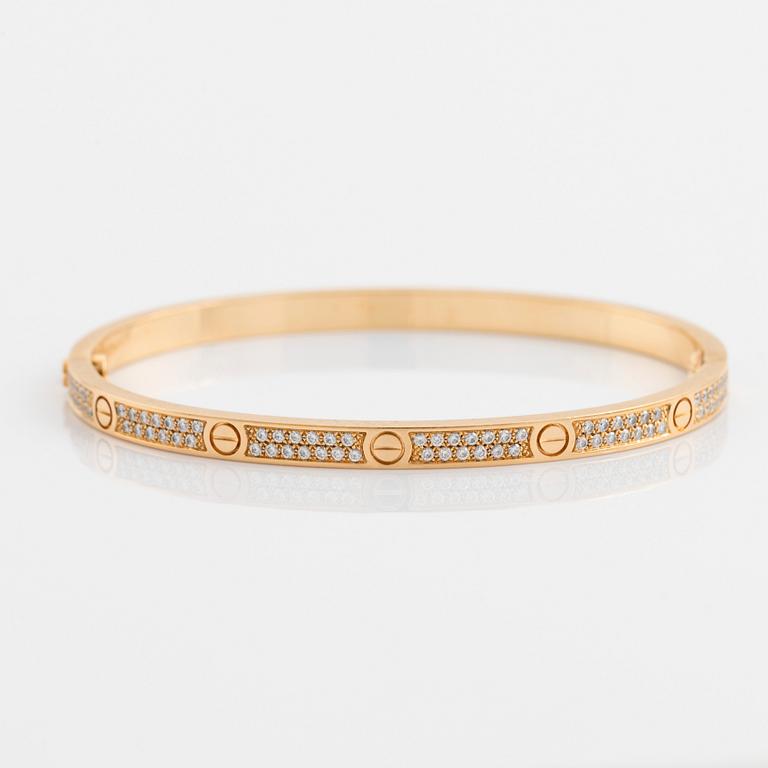 A Cartier "Love" bracelet small model in 18K gold set with round brilliant-cut diamonds.