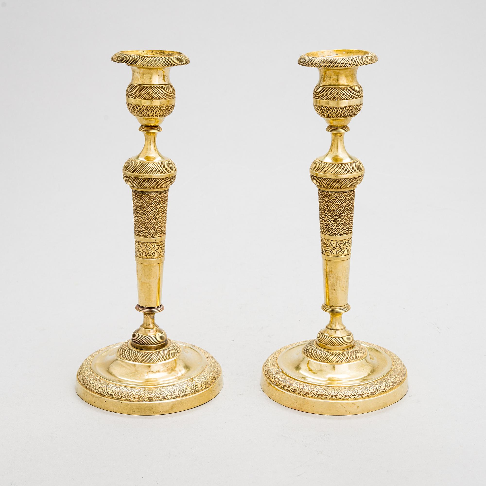 A pair of Empire bronze candlesticks from the first half of the 19th century.