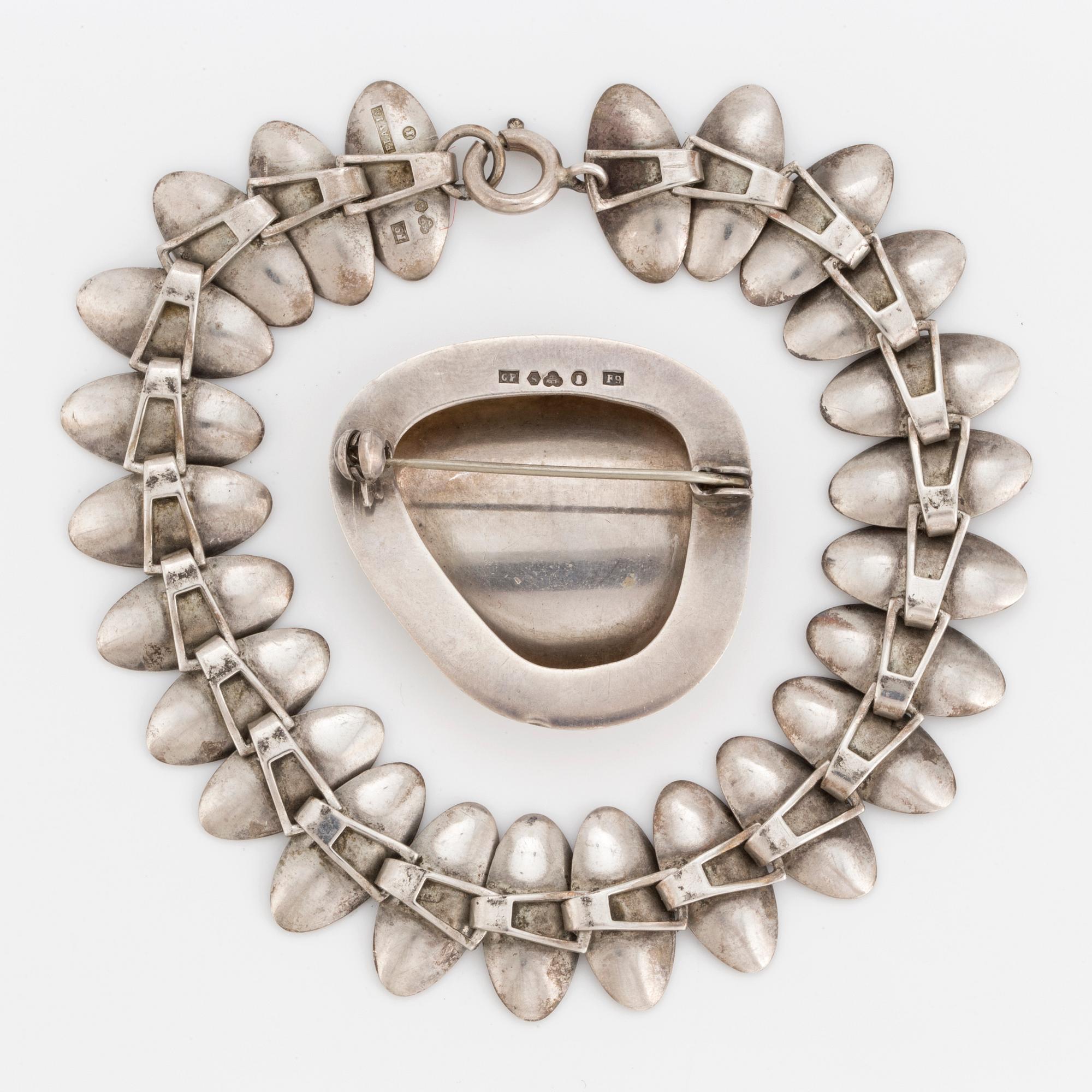 A 1950's silver bracelet and brooch.