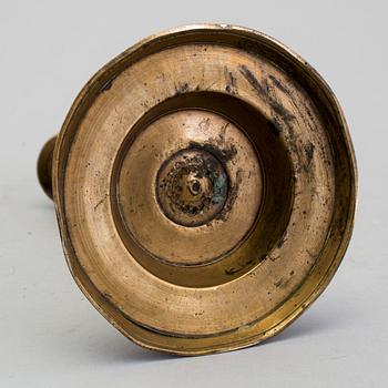 A 1500s bronze candlestick.