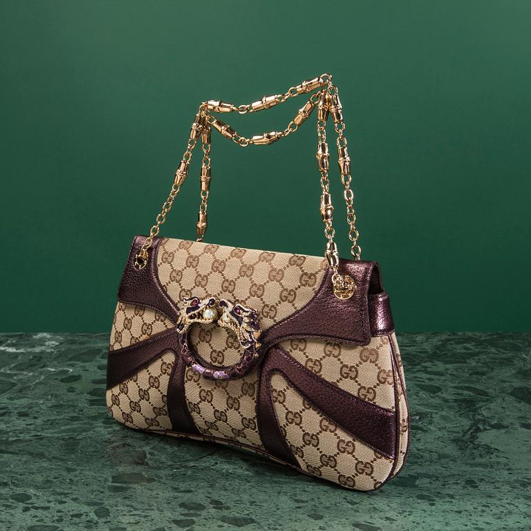 A bag VÄSKA, by Gucci.