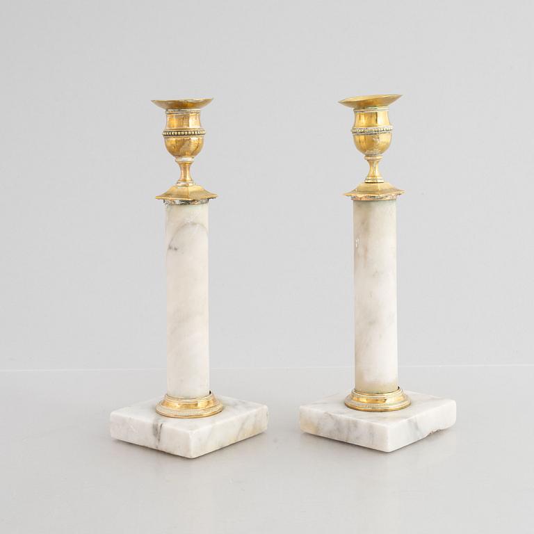 A pair of Gustavian gilt brass and marble candlesticks, late 18th century.