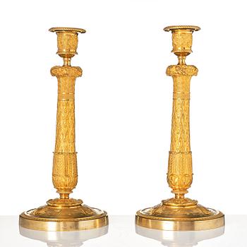 A pair of French Empire candlesticks.