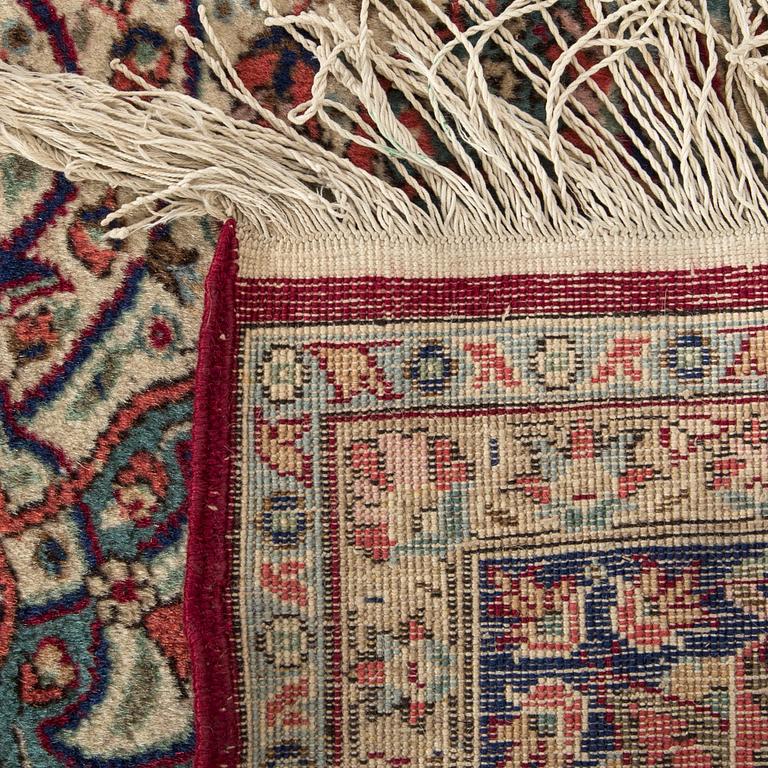 An old Kirman carpet ca 303 x 202 cm.