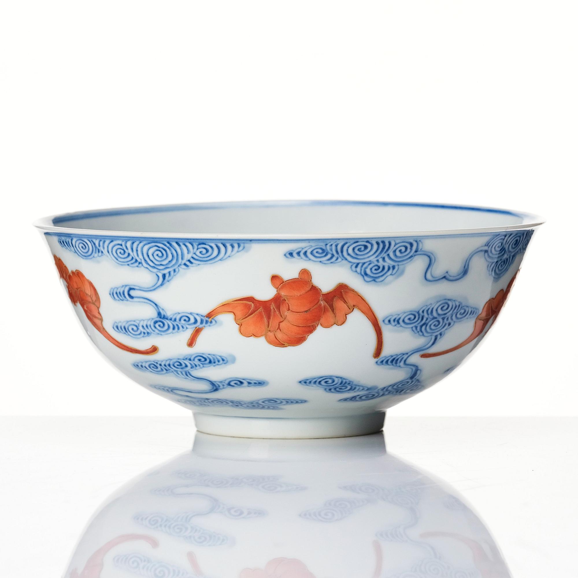 A Chinese iron-red-decorated blue and white Wufu bat bowl, late Qing dynasty, around 1900.
