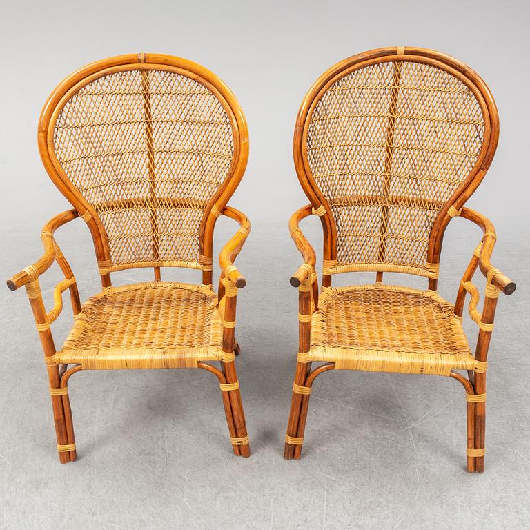 A pair of rattan chairs.