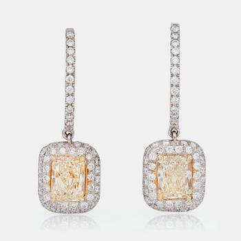 667. A pair of earrings with radiant-cut light yellow diamonds and pavé-set white diamonds.