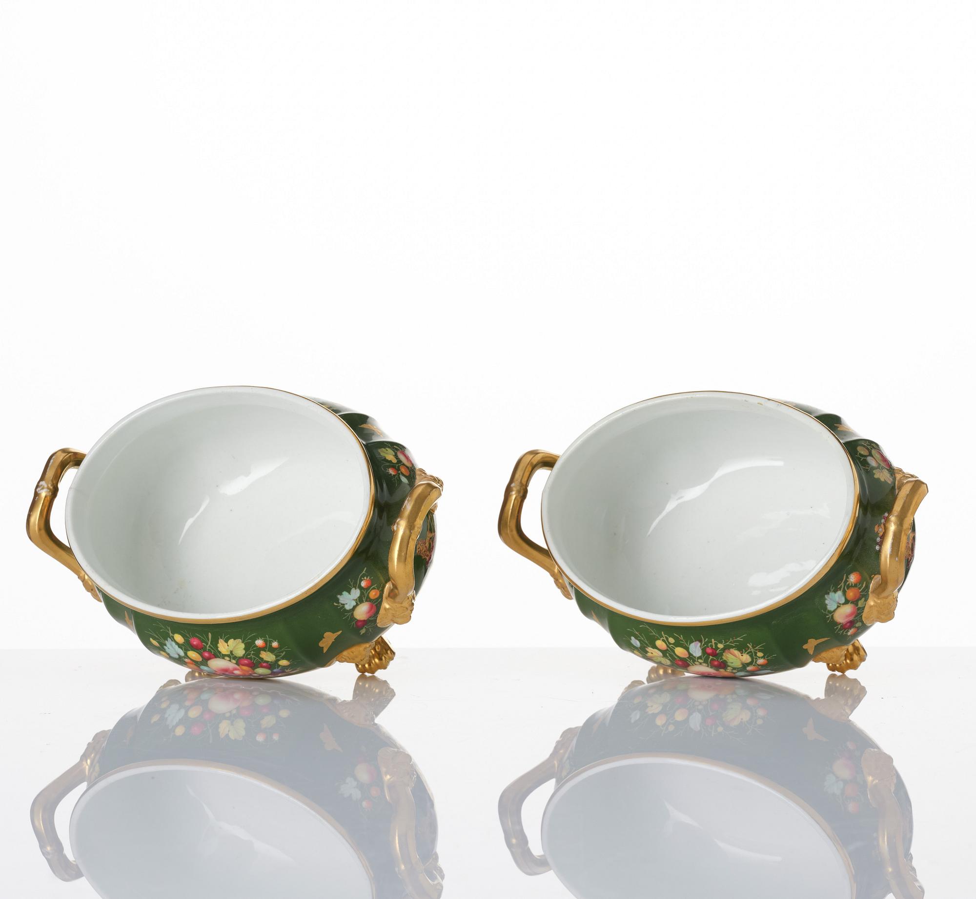 A pair of armorial butter tureens with covers and stands and two fruit dishes, Derby, England, circa 1830.