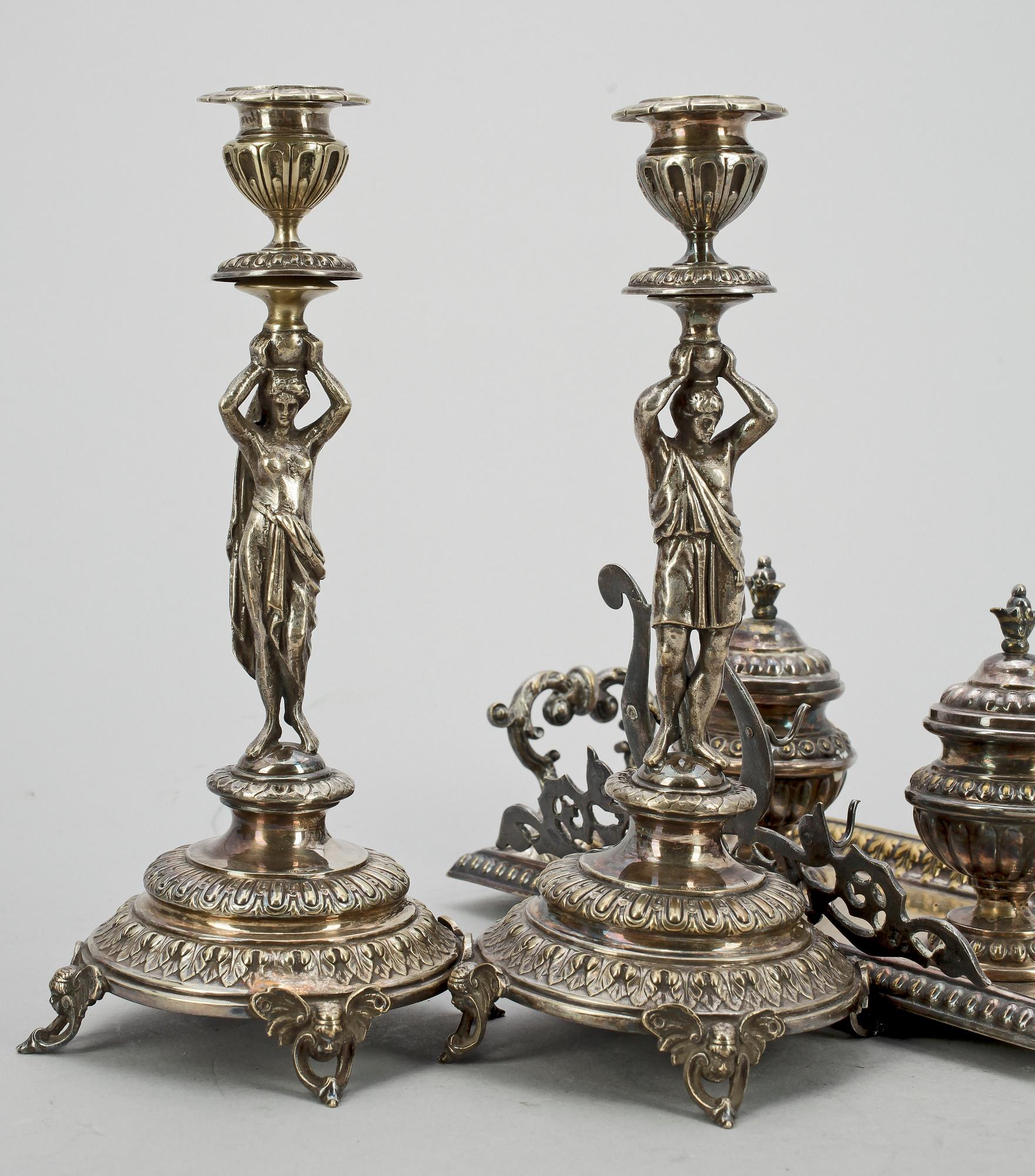 SKRIVSTÄLL samt ett par LJUSSTAKAR, nysilver, stileklekticism, bla GAB, omkring 1900.