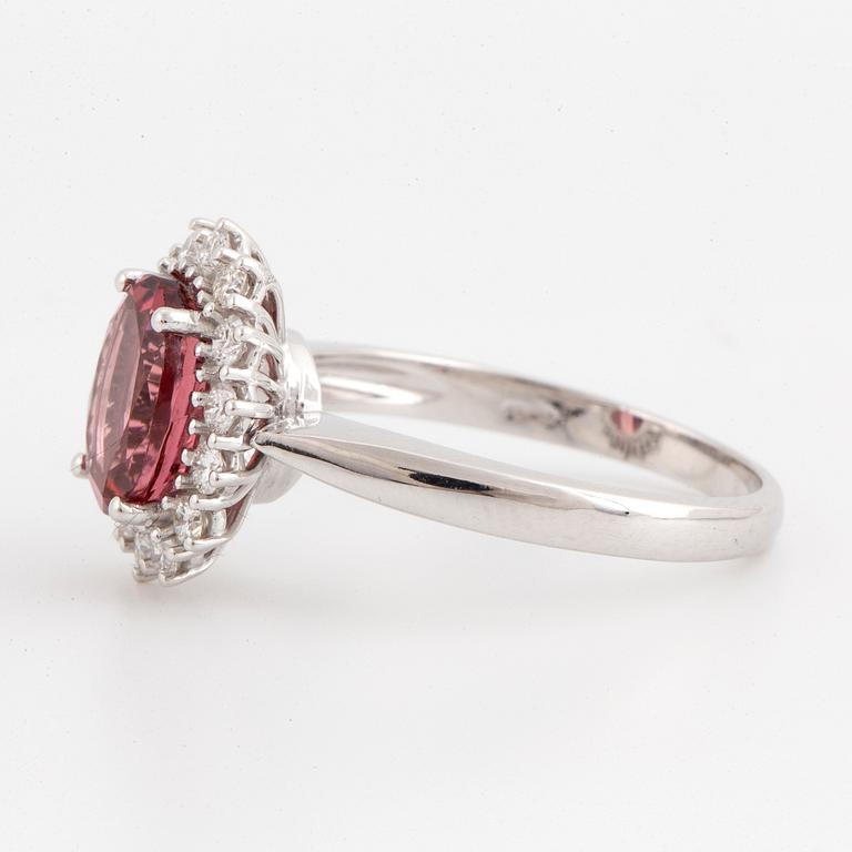 Oval pink faceted tourmaline and brilliant-cut diamond cluster ring.