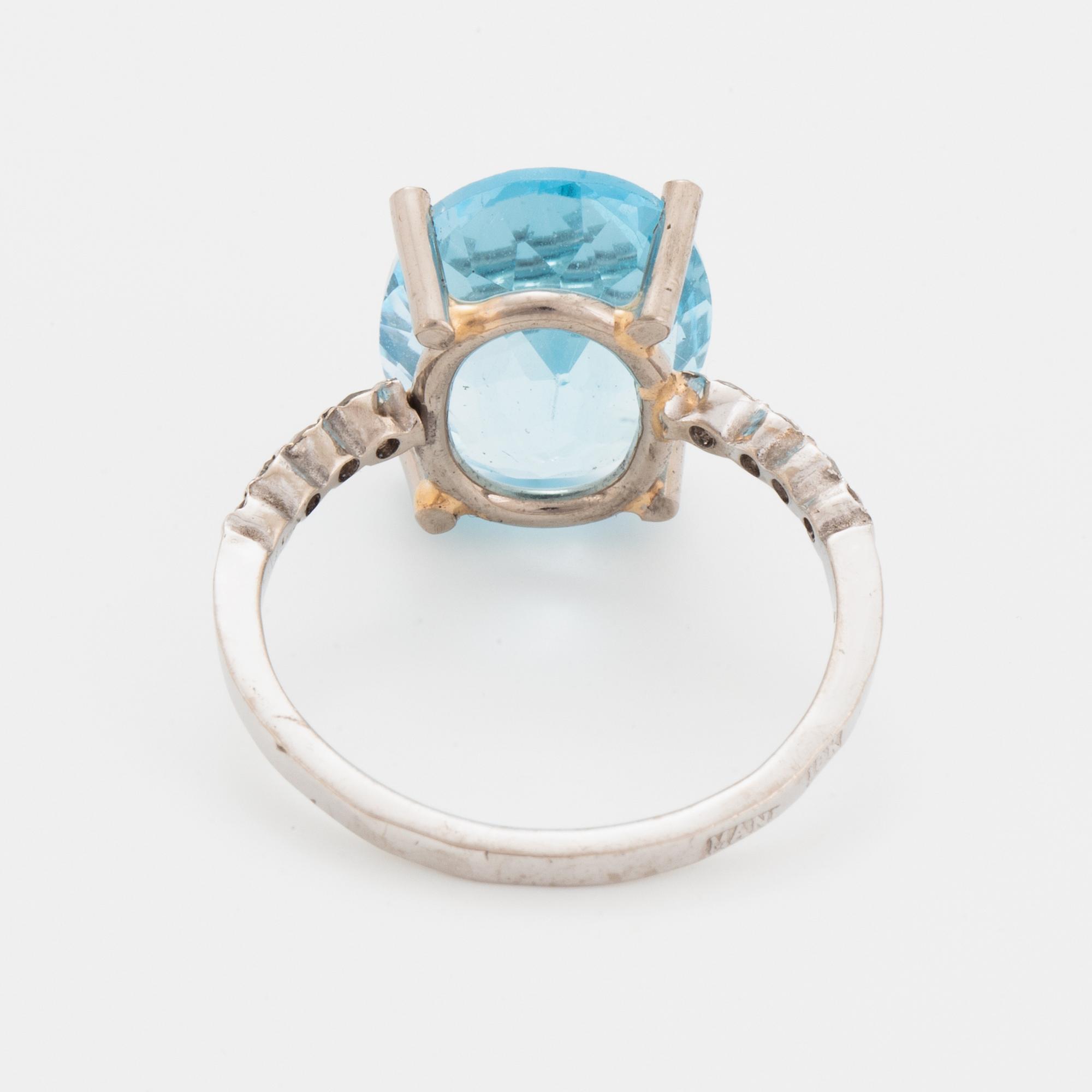 Oval faceted blue topaz and brilliant-cut diamond cocktail ring.