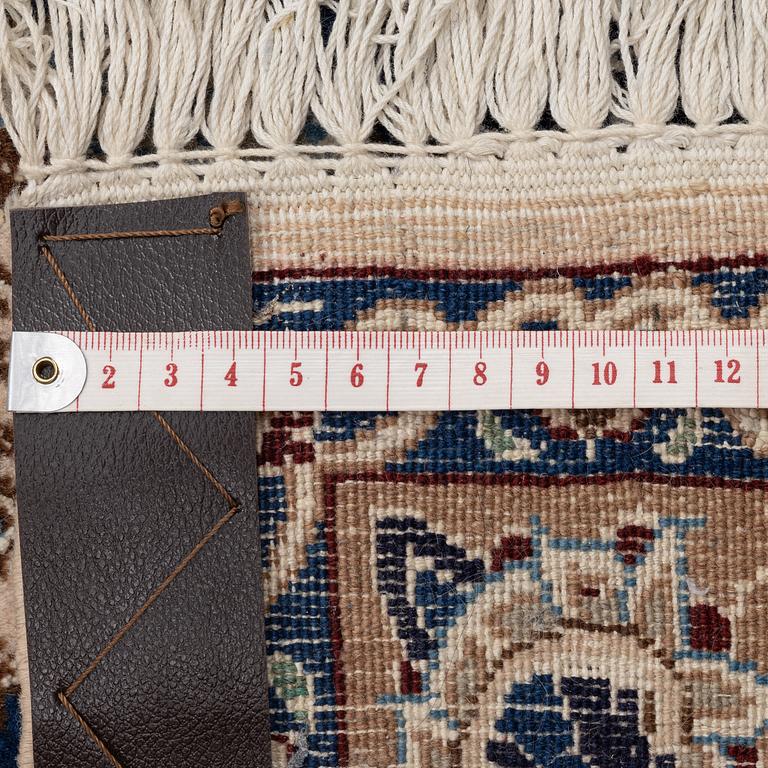 A Nain part silk carpet, c. 535 x 340 cm.