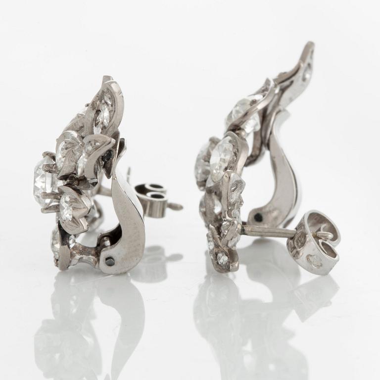 A pair of earrings set with old-cut diamonds.