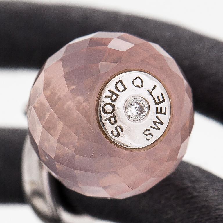 Ole Lynggaard, A silk, rose quartz, diamond 0.015 ct and 18K white gold bracelet. Denmark.