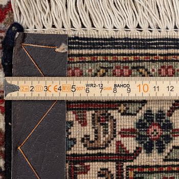 A signed Tabriz carpet, c. 385 x 300 cm.