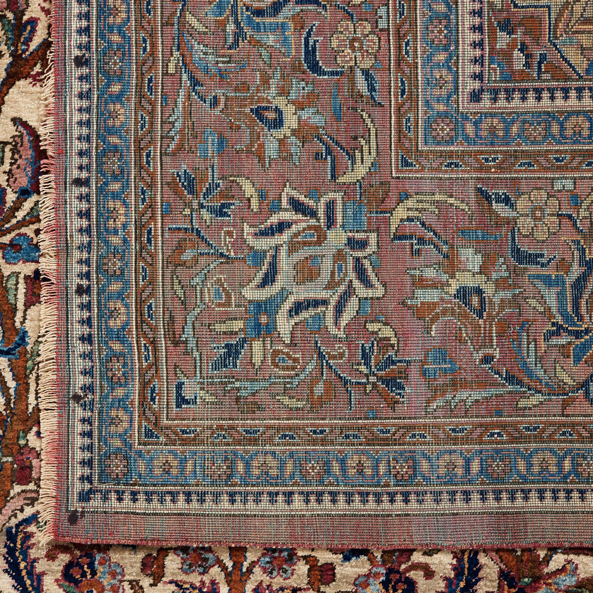A RUG. A semi-antique silk Kashan. 205,5 x 131,5 cm.