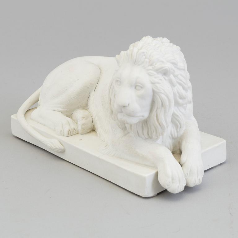 A bisquit figure of a 'reclining lion', Royal Copenhagen, Denmark, 19th Century.