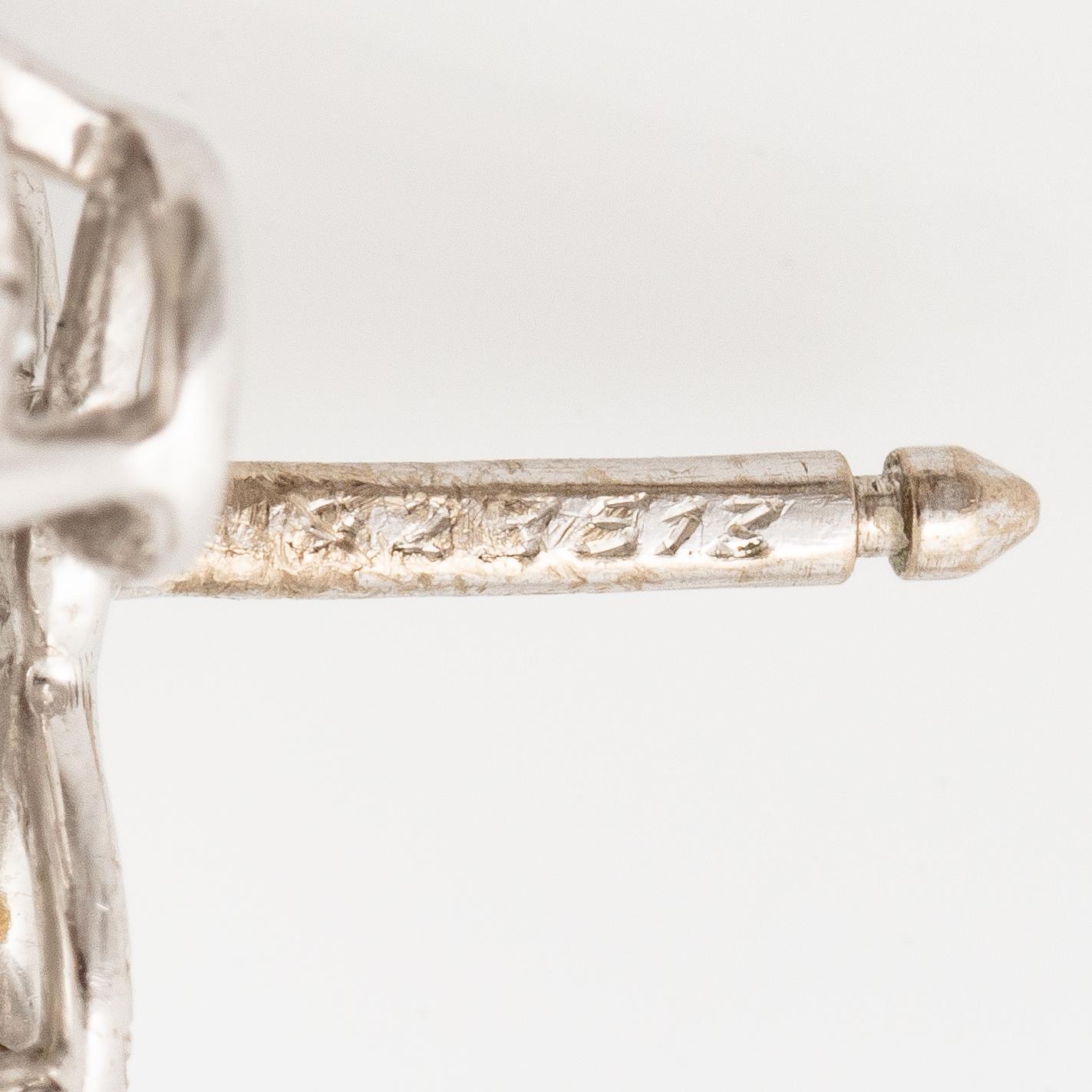 A pair of Cartier earrings in 18K white gold with six heart-shaped brilliant-cut diamonds.