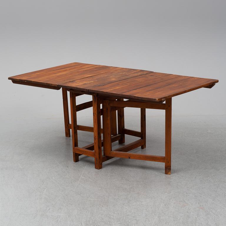 A stained pine gate-leg table, 19th Century.