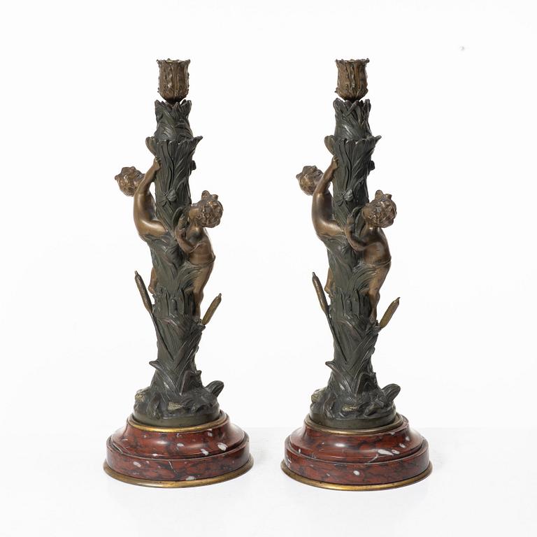 a pair of bronze and marble candle sticks, after a model by Houdon, late 19th century.