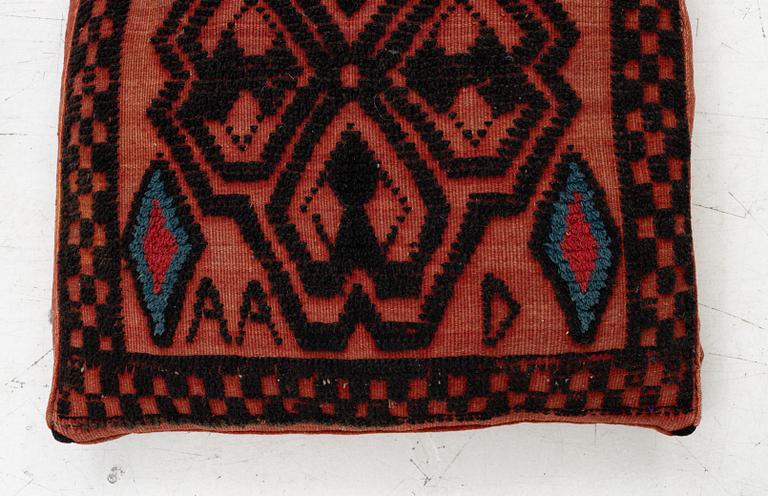 A carriage cushion, knotted pile in relief, ca 106 x 47, southwest of Scania, Sweden, circa 1800.