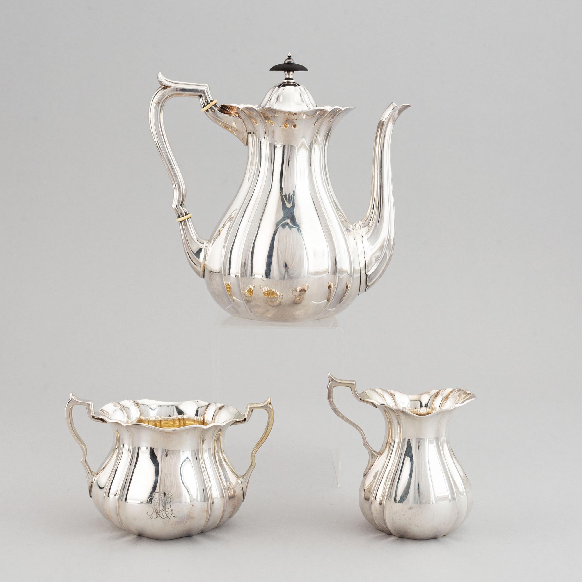 A swedish parcel-gilt coffee pot, creamer and suga bowl.