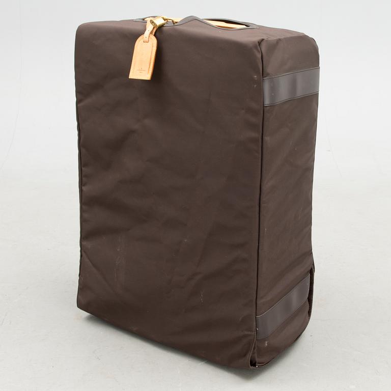 A Monogram Canvas Pégase 65 Suitcase with a Protective Cover.