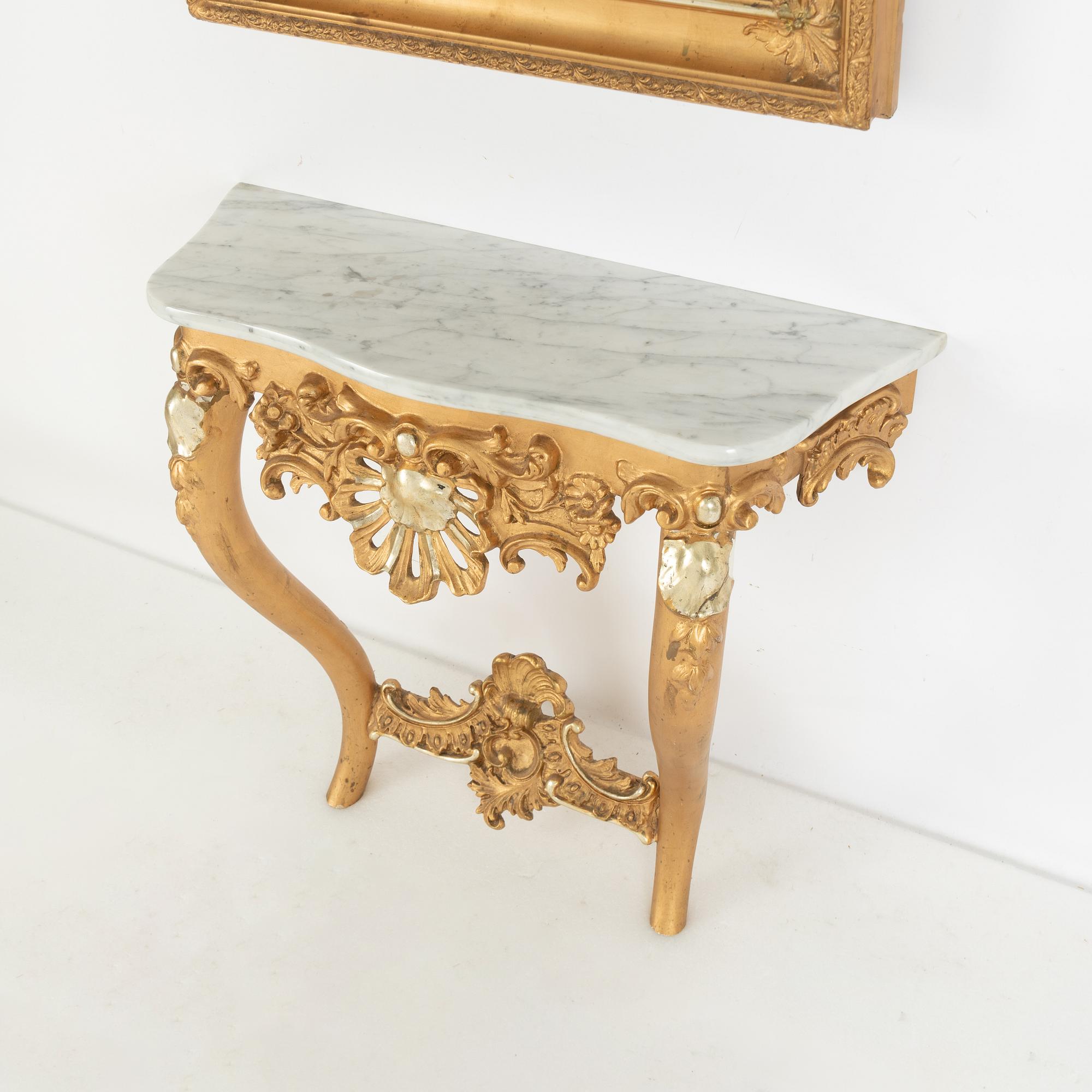 A rococo-style mirror and console table, around 1900.