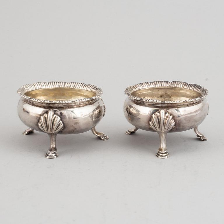 Two pairs of English 18th century silver salt-cellars, marked in London 1762 and 1769.