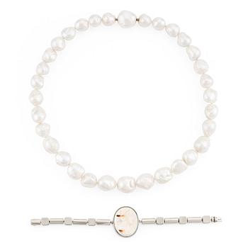 A Gaudy necklace with cultured South Sea pearls, a platinum bracelet, and two clasps.