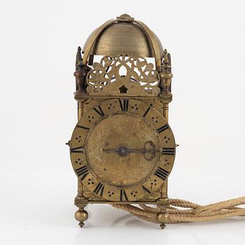 A Baroque brass lantern clock with bracket marked Andrew Prime Londini Fecit (active 1641- ca.1682).