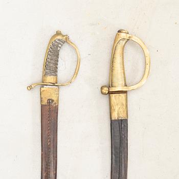 To cutlasses, 19th century, with scabbards.