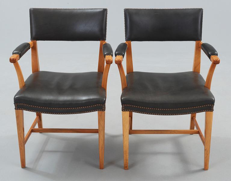 A pair of Josef Frank walnut and black leather armchairs, Svenskt Tenn, model 695.