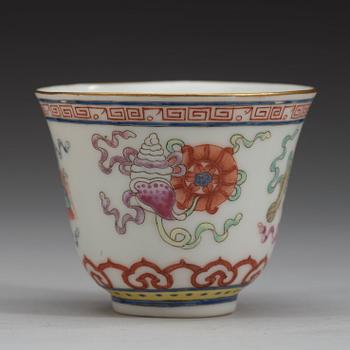 A set of eleven famille rose ba jixiang wine cups, Qing dynasty, with Guangxu six character mark and period (1874-1908).