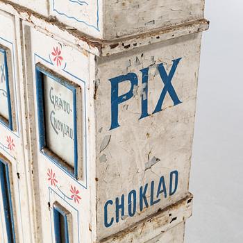 A circa turn of the century candy dispenser.