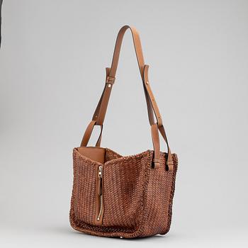 Loewe, a brown woven leather handbag.