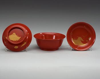 A set of eight red lacquered Japanese bowls with covers, first half of 20th Century.