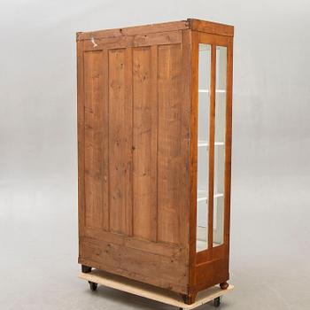 An early 1900s walnut display cabinet.