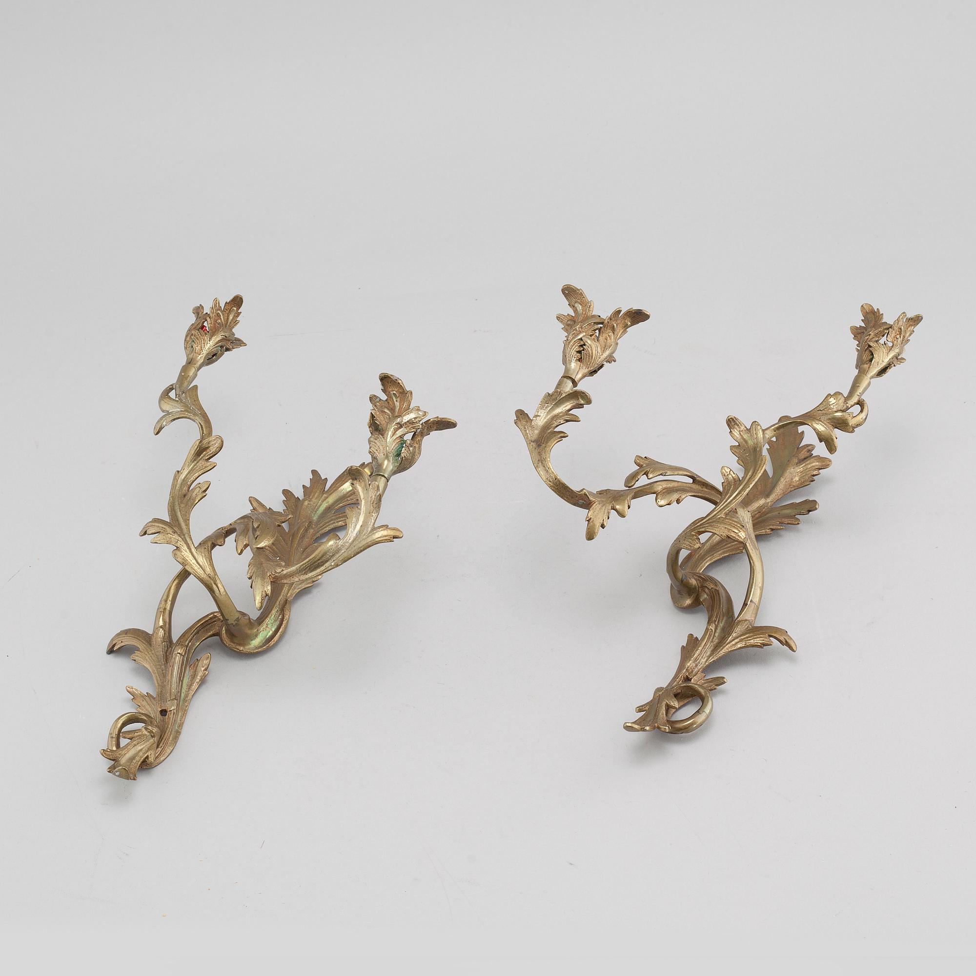 A pair of Louis XV-style brass wall sconces first half of the 20th century.