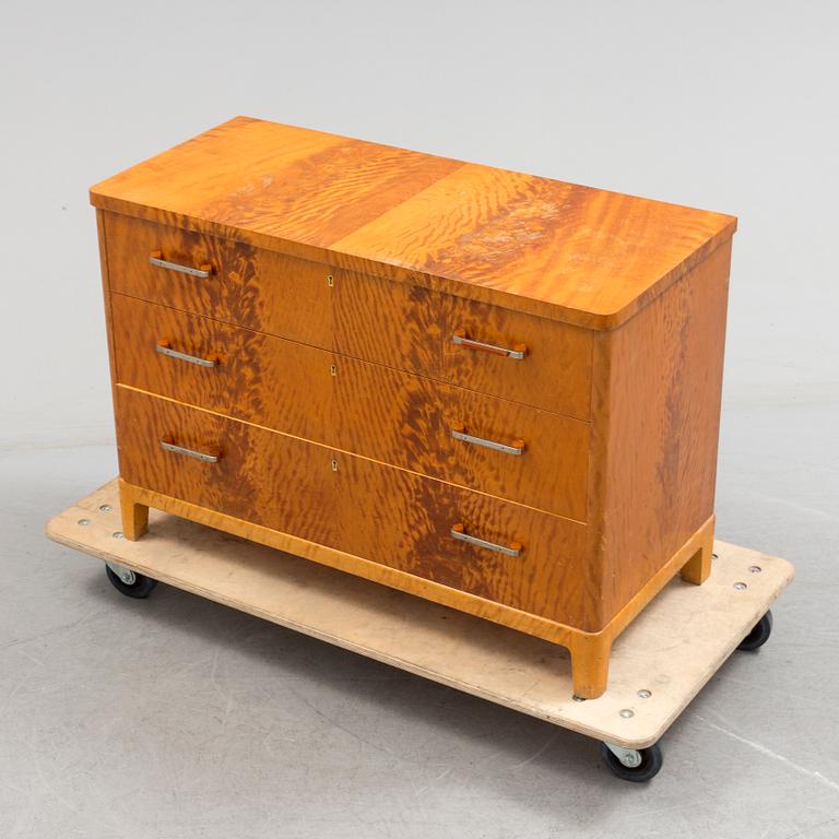 A 1930s art déco birch veneered chest of three drawers.