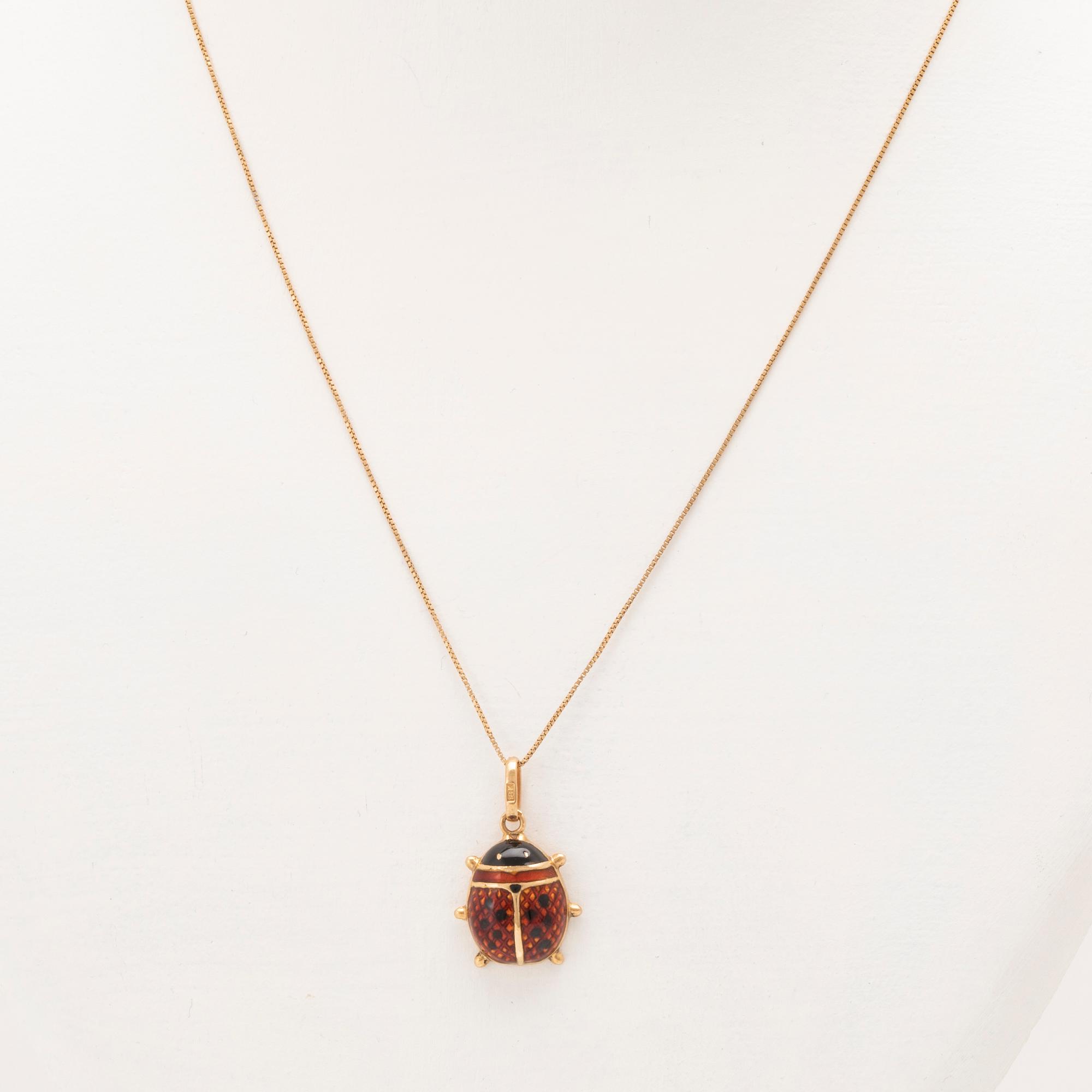 An 18K gold and enamel necklace.