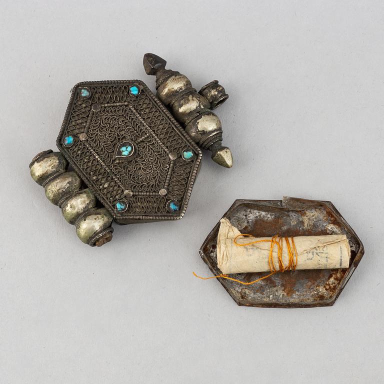 Two metal pendants with turkoise inlay, Tibet, circa 1900.