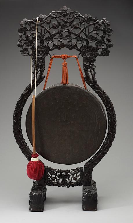 A bronze gong with a wooden stand, Qing dynasty.